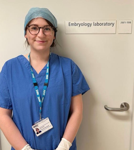 Ellie Aston, an embryologist, wearing her uniform outside of the Embryology Laboratory.